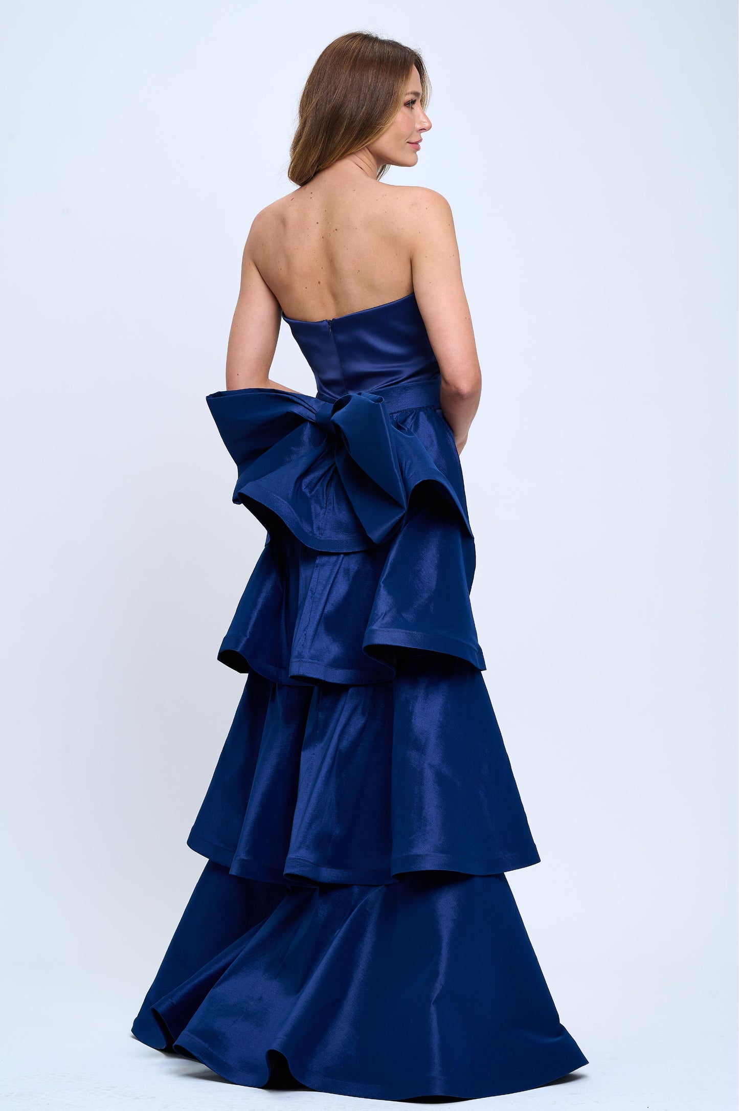 Strapless slit back dress and detachable belted oversized bow ruffle layered train