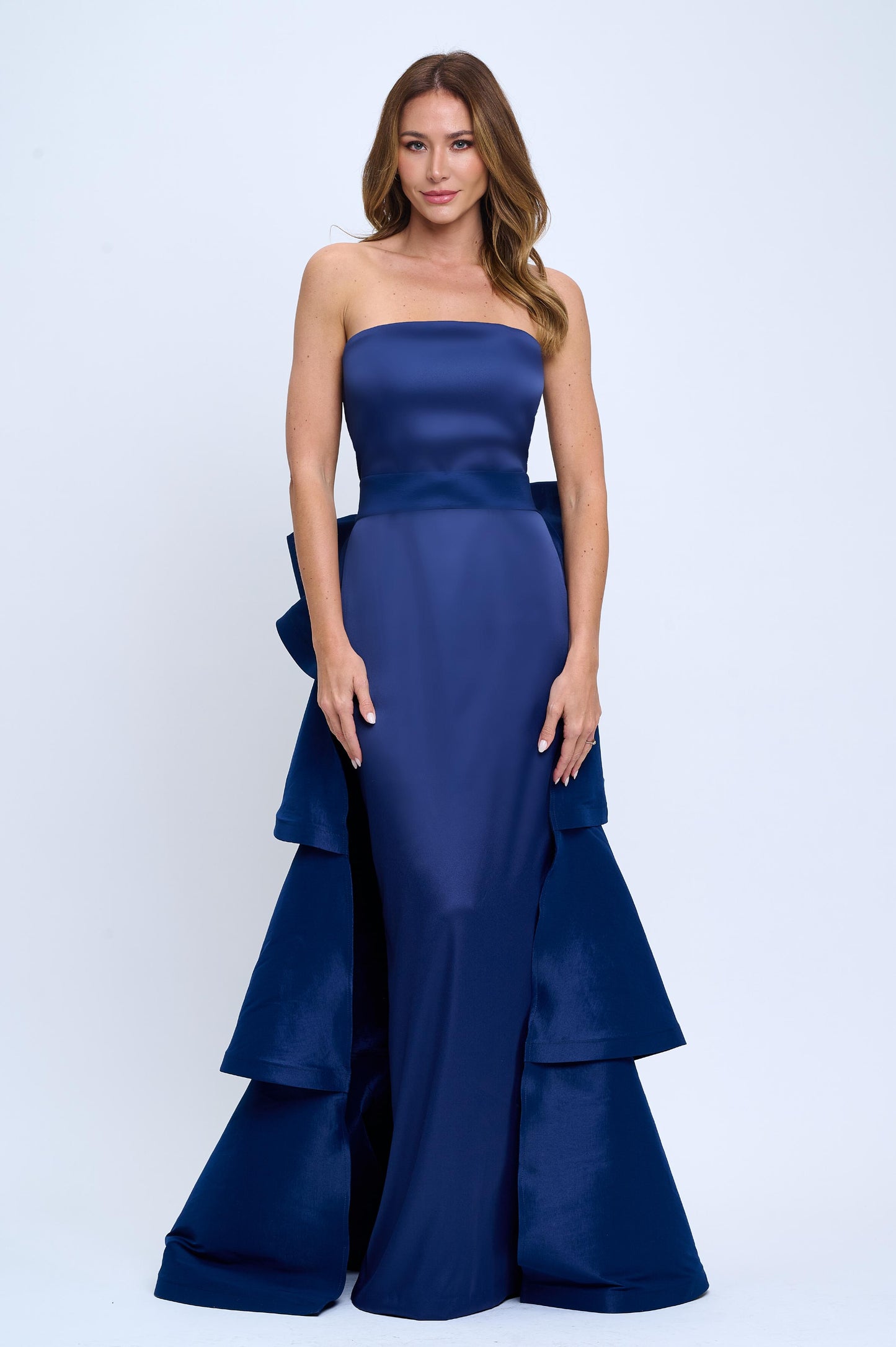 Strapless slit back dress and detachable belted oversized bow ruffle layered train