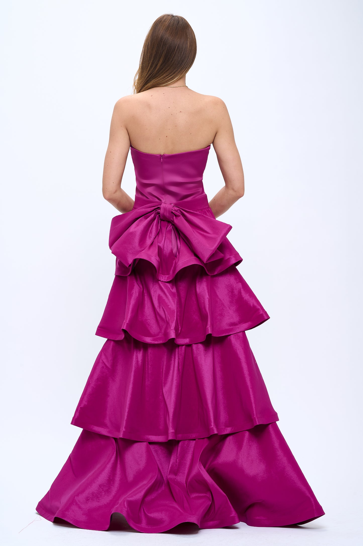 Strapless slit back dress and detachable belted oversized bow ruffle layered train