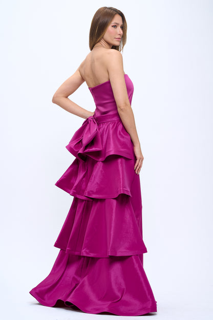Strapless slit back dress and detachable belted oversized bow ruffle layered train