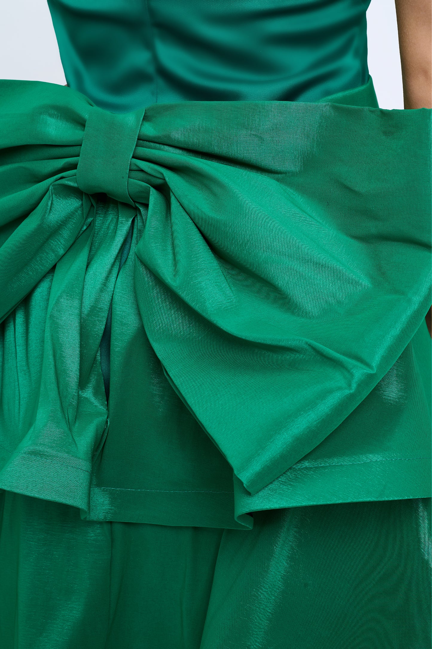 Strapless slit back dress and detachable belted oversized bow ruffle layered train