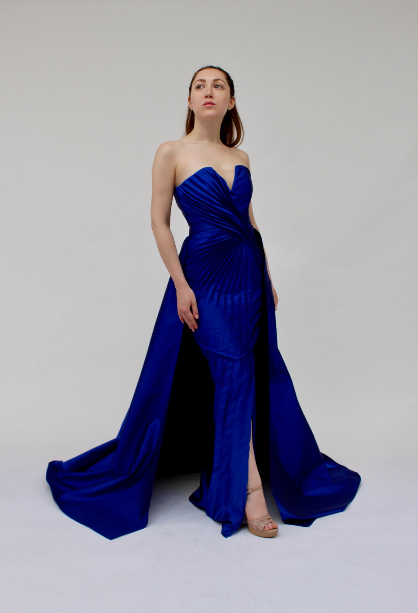 Strapless cascading pleated fitted gown with detachable train